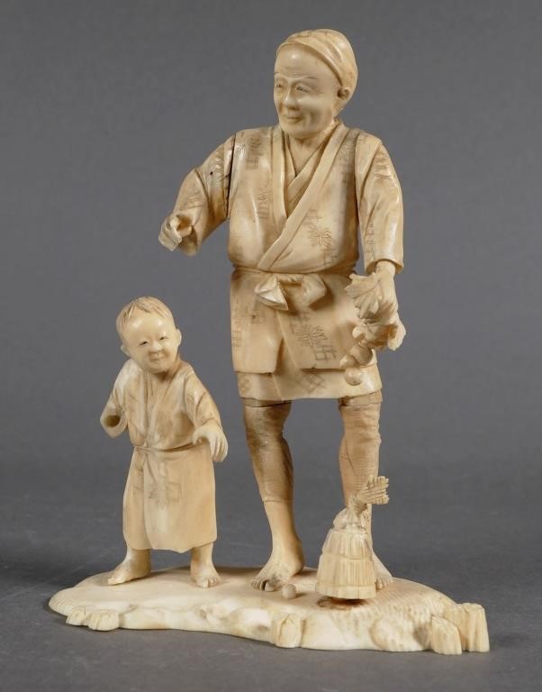 Appraisal: Old ivory carving of man and child high Child is