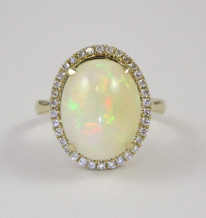 Appraisal: OPAL DIAMOND AND FOURTEEN KARAT GOLD RING with round-cut diamonds