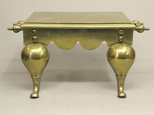 Appraisal: A Victorian style brass footman trivet Of rectangular outline flanked