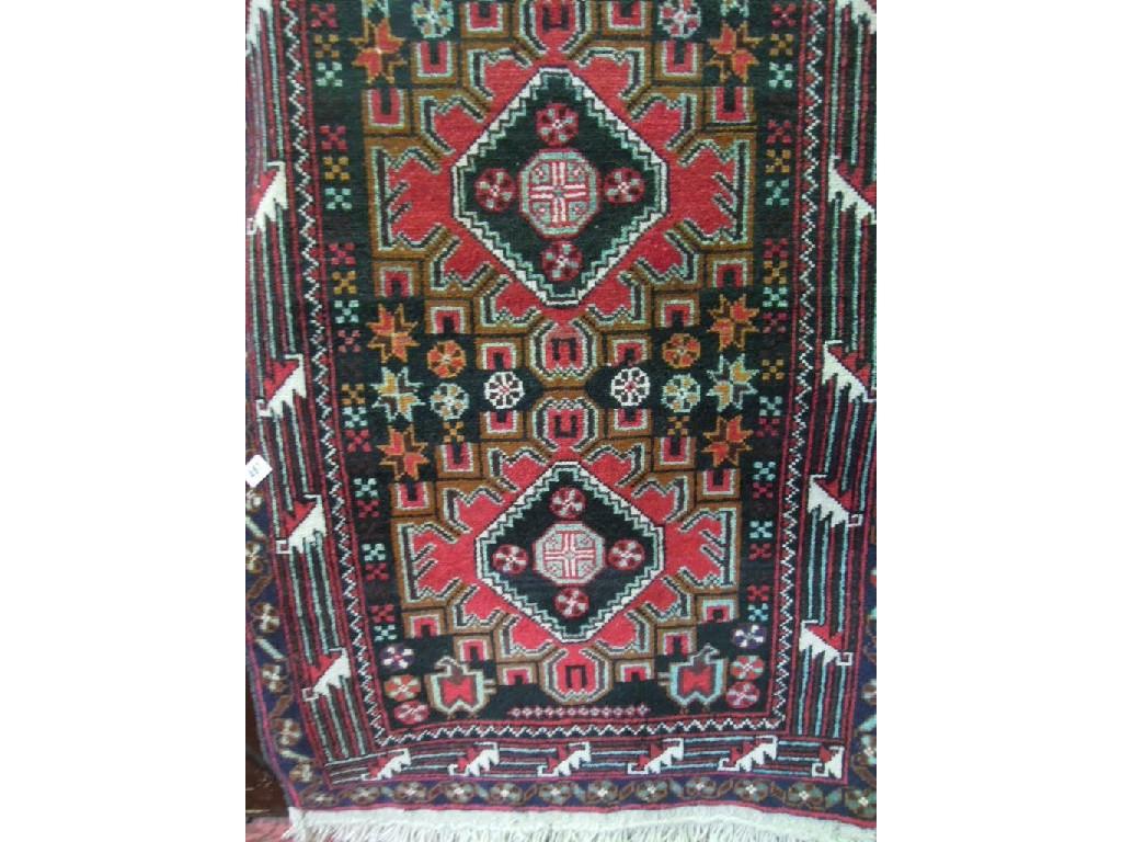 Appraisal: A Middle Eastern design rug with two central geometric medallions