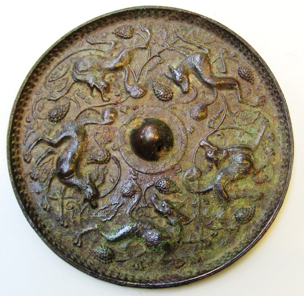 Appraisal: A bronze mirror of disc form decorated with five feline