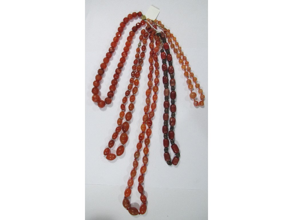 Appraisal: Lot comprising four strings of cornelian beads and a string