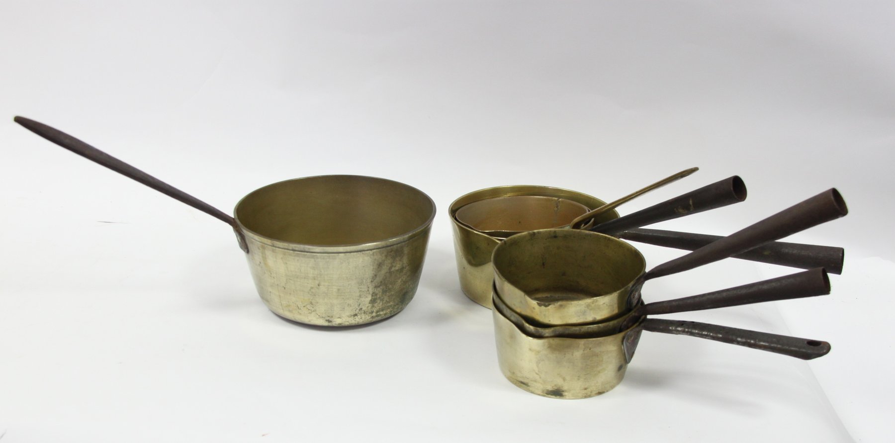 Appraisal: Six brass saucepans with iron handles and another with brass