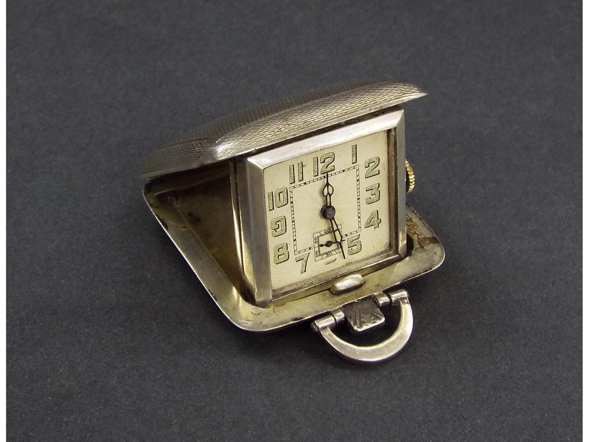 Appraisal: Art Deco silver pocket travel watch within an engine turned