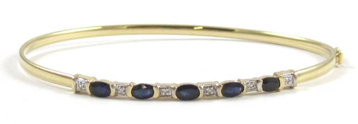 Appraisal: SAPPHIRE DIAMOND AND FOURTEEN KARAT GOLD BANGLE set with five