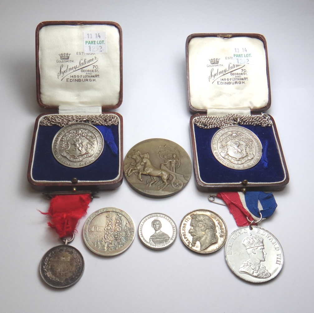 Appraisal: Two silver medallions each detailed Presented by Dobbie Co Ltd