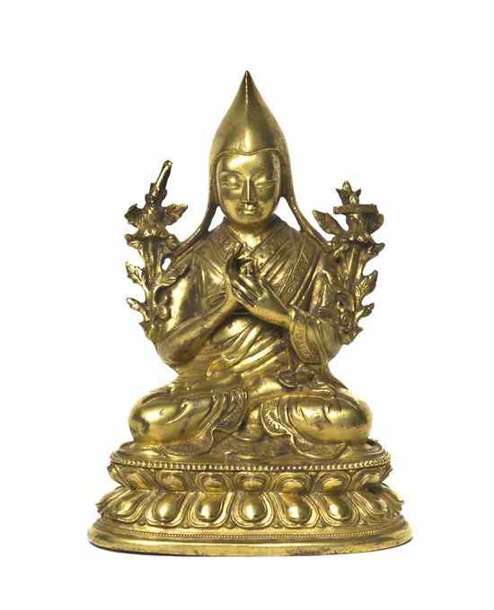 Appraisal: A Gilt Bronze Model of a Buddhist Disciple depicted with