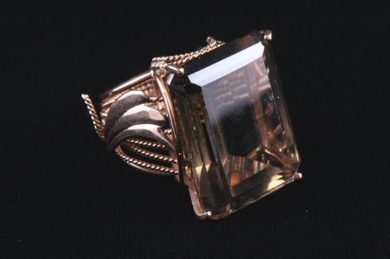 Appraisal: K YELLOW GOLD AND SMOKY TOPAZ RING Rectangular-cut topaz measuring