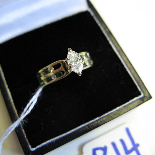 Appraisal: DIAMOND EMERALD AND FOURTEEN KARAT GOLD RING centering a marquise-cut