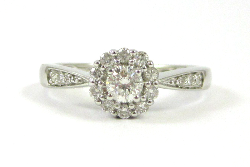 Appraisal: DIAMOND AND FOURTEEN KARAT WHITE GOLD RING with round-cut diamonds