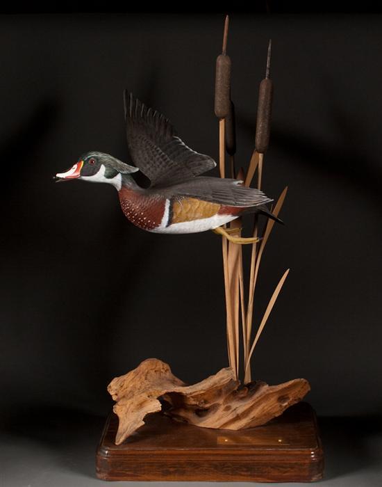 Appraisal: Carved and polychromed wood duck in flight with similar carved