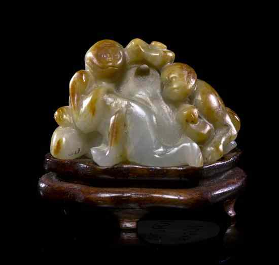 Appraisal: A White Jade and Russet Toggle of Monkeys of white