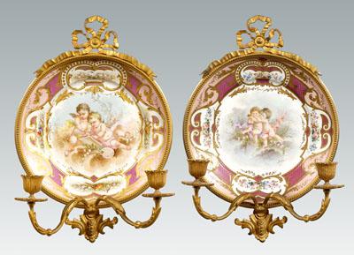 Appraisal: Ormolu mounted S vres plates hand painted cupids in clouds