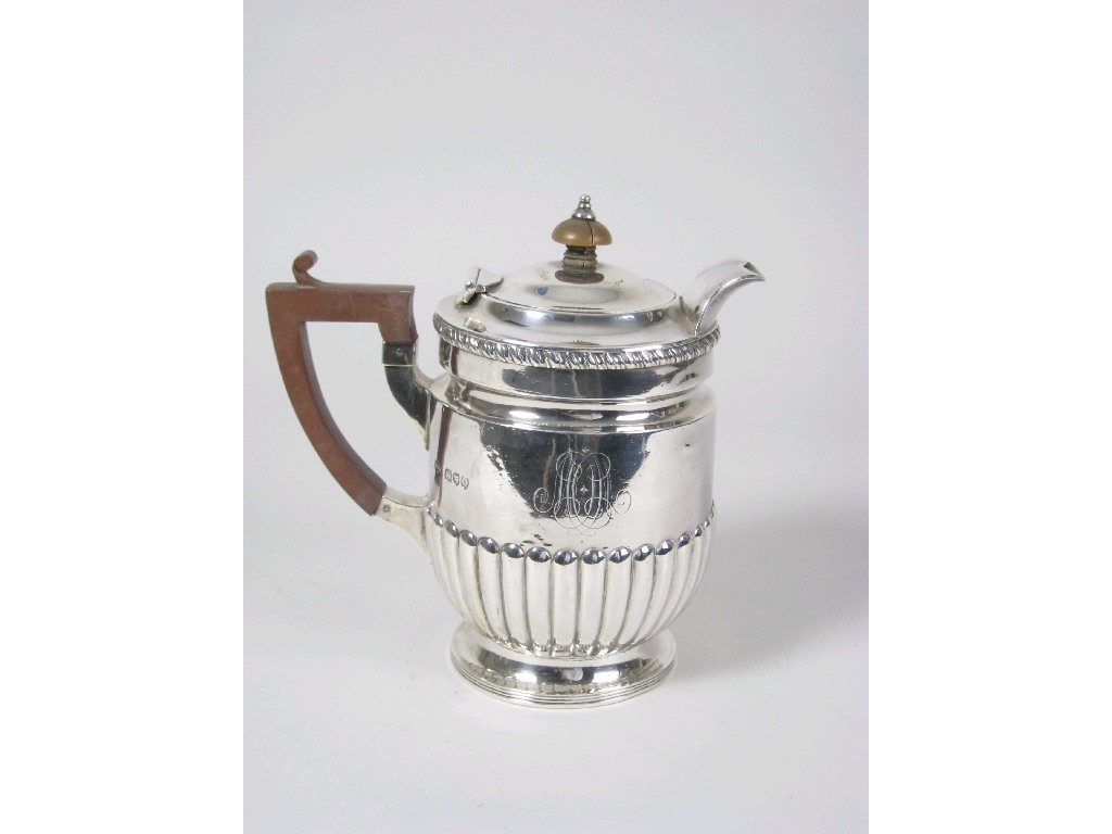 Appraisal: A Victorian Hot Water Jug with fluted body wooden handle