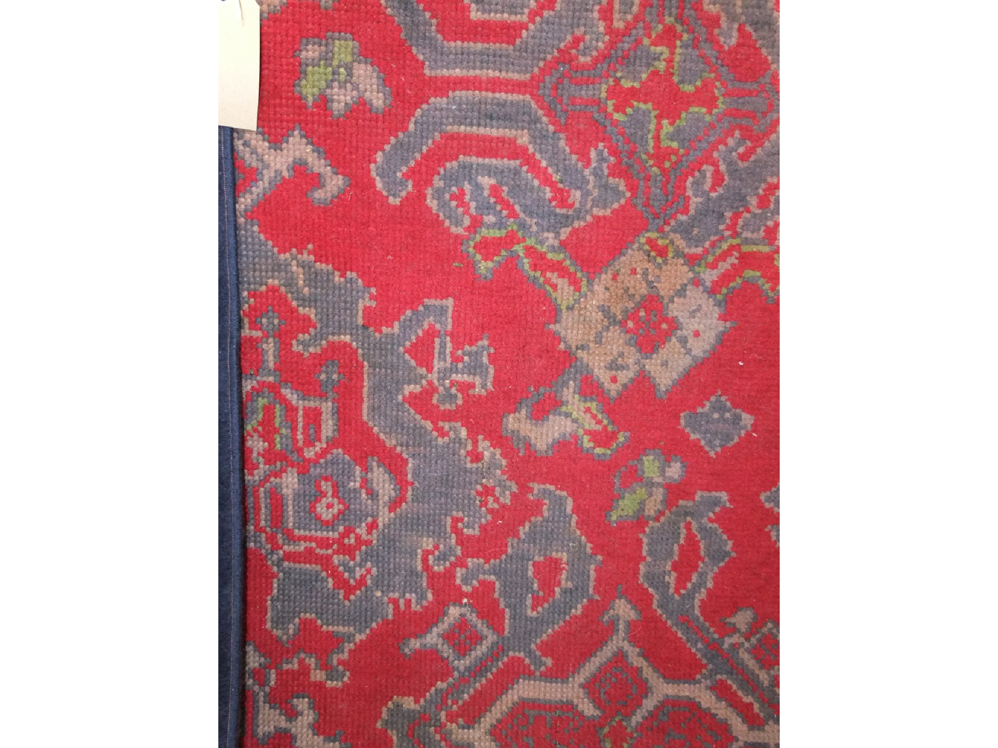 Appraisal: A heavy wool work carpet the red field interspersed with