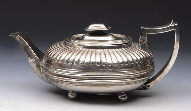 Appraisal: A GEORGE III OVAL SHAPED TEAPOT with fluted upper body