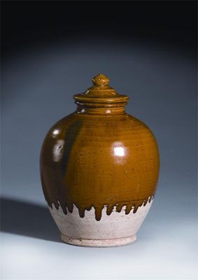 Appraisal: A Chinese amber-glazed pottery jar and cover Tang dynasty -