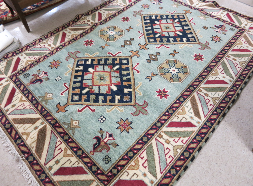 Appraisal: HAND KNOTTED ORIENTAL CARPET Indo-Kazak featuring two geometric medallions and