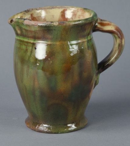 Appraisal: Shenandoah Valley Polychrome Cream PitcherWith heavy copper glaze over slight