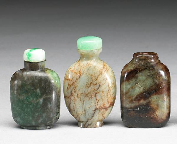 Appraisal: Three serpentine snuff bottles The first of flattened rectangular form