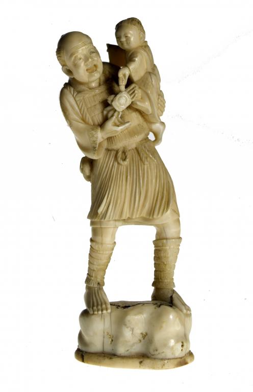 Appraisal: AN IVORY FIGURE OF A FISHERMAN the child carried in