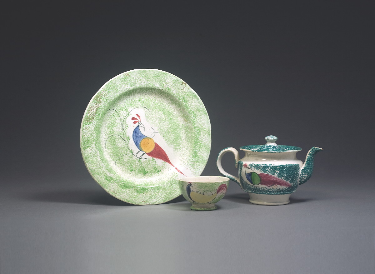 Appraisal: STAFFORDSHIRE GREEN SPATTERWARE 'PEAFOWL' PATTERN CHILDREN'S TEAPOT AND A TEACUP