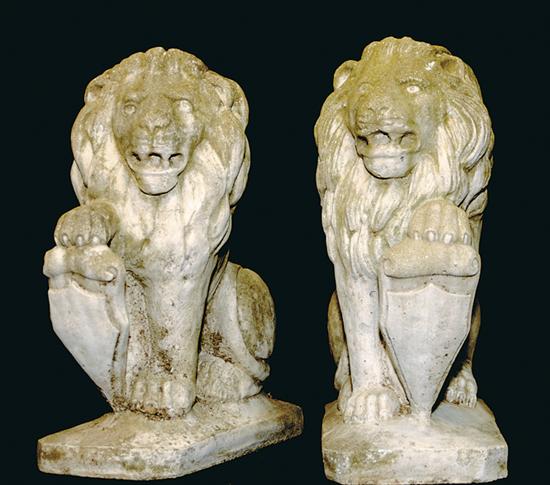 Appraisal: Pair cast-stone lions lions passant with paw holding tablet on