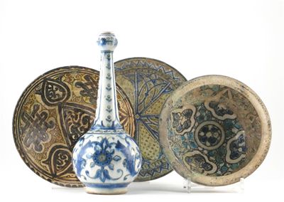 Appraisal: Four Persian bowls decorated with stylized geometric patterns in blue