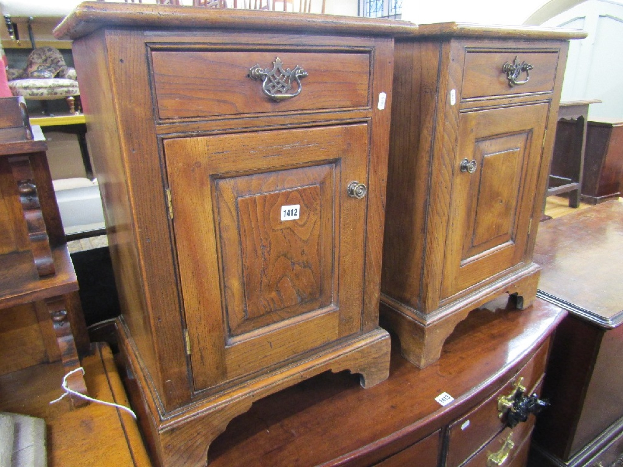 Appraisal: A pair of Georgian style elm side cupboards each enclosed