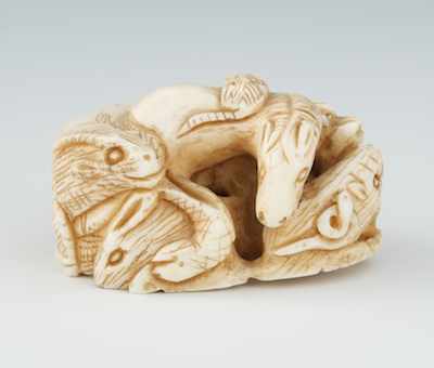 Appraisal: A Carved Ivory Netsuke of Animals Animal grouping including a