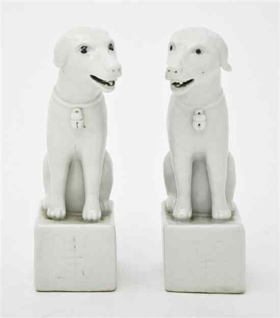 Appraisal: A Pair of Chinese Blanc de Chine Dogs each raised