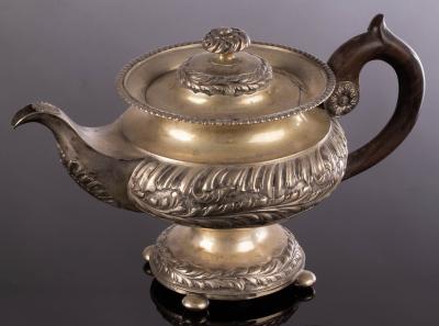 Appraisal: A Romanian white metal teapot with spiral ribbing and foliate