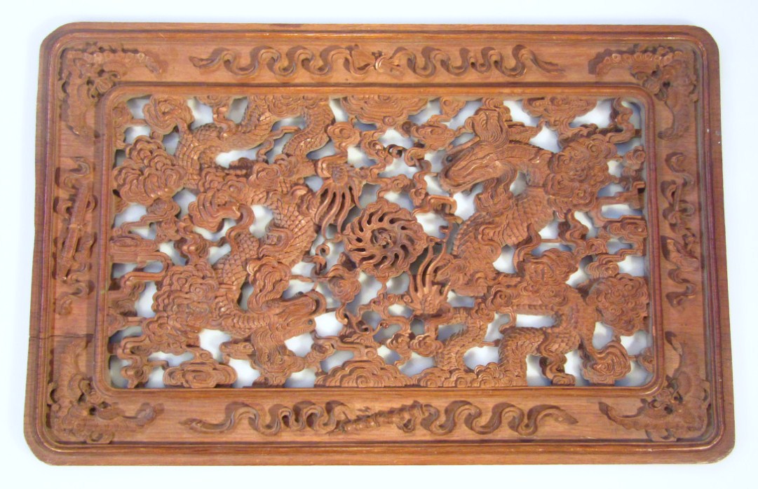 Appraisal: A heavily carved thC oriental sandalwood screen the centre decorated