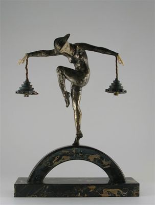 Appraisal: Harlequin' a bronze and ivory figural lamp base cast from