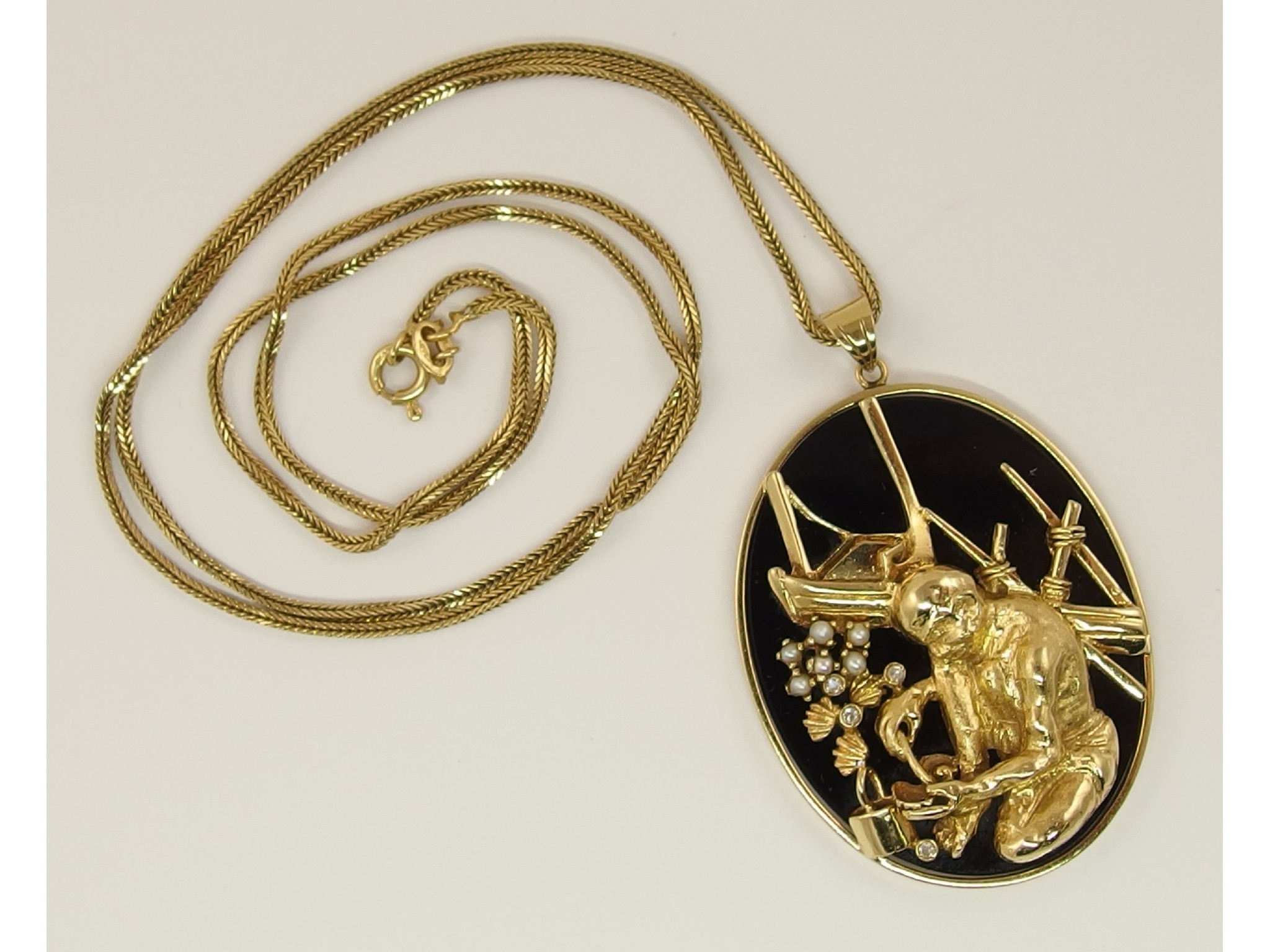 Appraisal: An ct pendant depicting a pearl fishermanset against an onyx