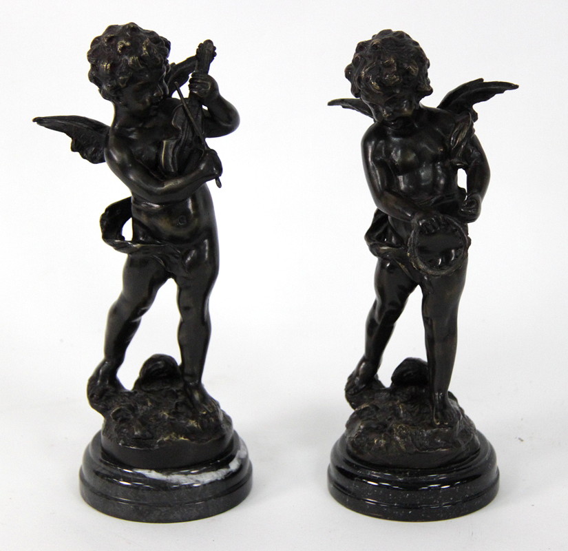 Appraisal: A pair of bronze cherubs