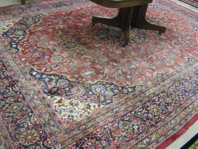 Appraisal: PERSIAN MASHAD CARPET floral and central floral medallion design on