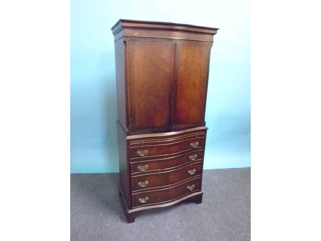 Appraisal: A reproduction mahogany cabinet the serpentine fronted top with two