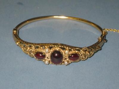 Appraisal: A CT GOLD BANGLE with ropework hinged top containing three