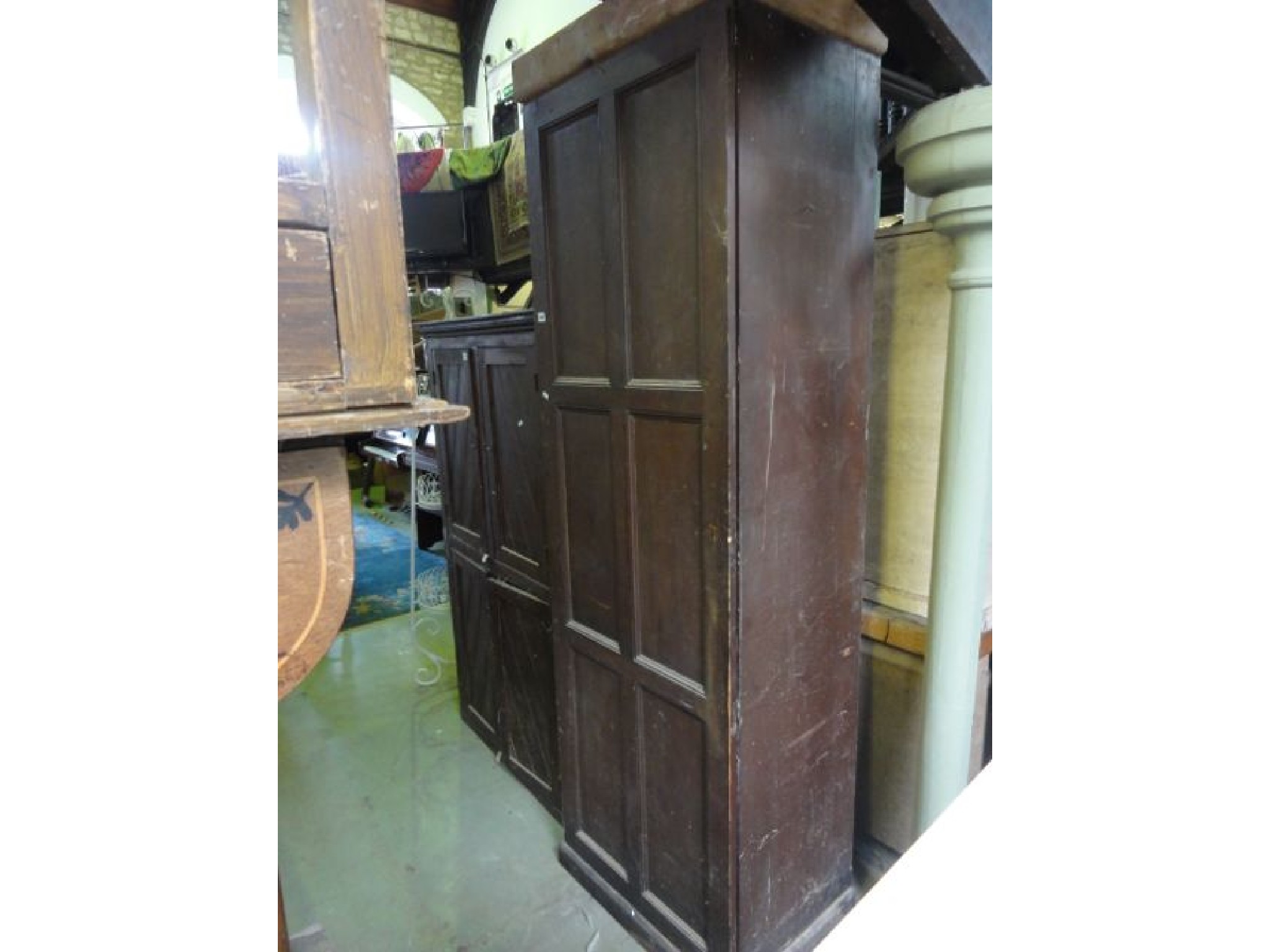 Appraisal: A tall th century stained pine side cupboard enclosed by