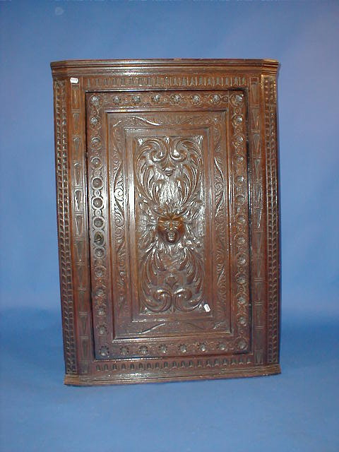 Appraisal: A Georgian carved oak hanging corner cupboard