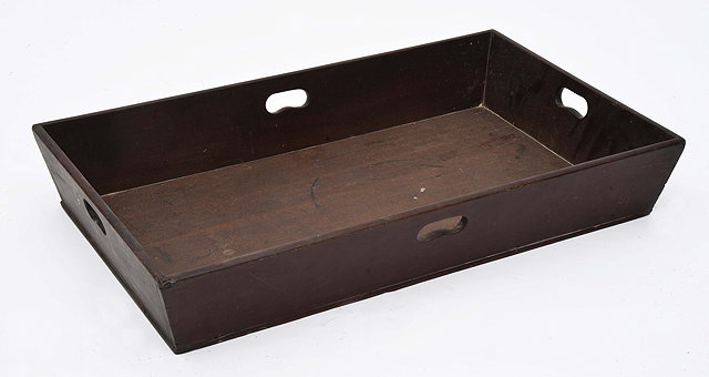 Appraisal: A GEORGIAN RECTANGULAR MAHOGANY BUTLERS TRAY the waisted sides pierced