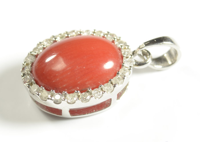 Appraisal: CORAL AND FOURTEEN KARAT GOLD PENDANT The white gold pendant