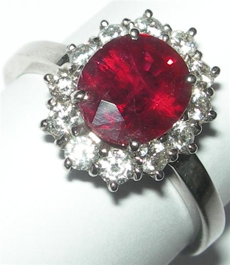 Appraisal: An ct white gold mounted ruby and diamond cluster ring