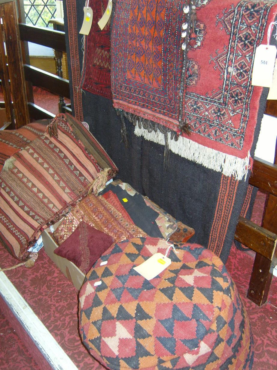 Appraisal: A quantity of eastern rugs saddlebags cushions etc together with