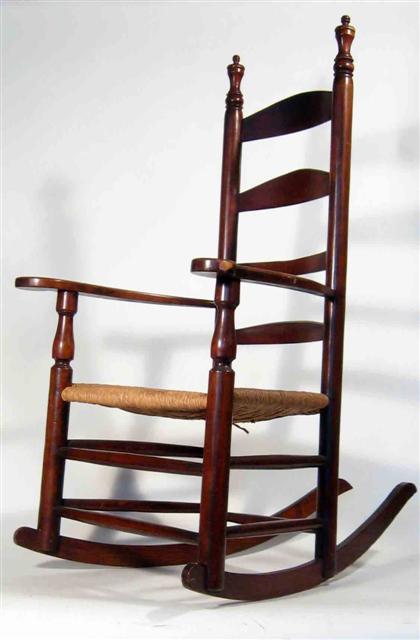 Appraisal: Ladder back rocking arm chair with rush seat H in