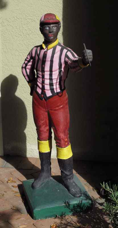 Appraisal: PAINTED CONCRETE LAWN JOCKEY Repainted at some point '' h