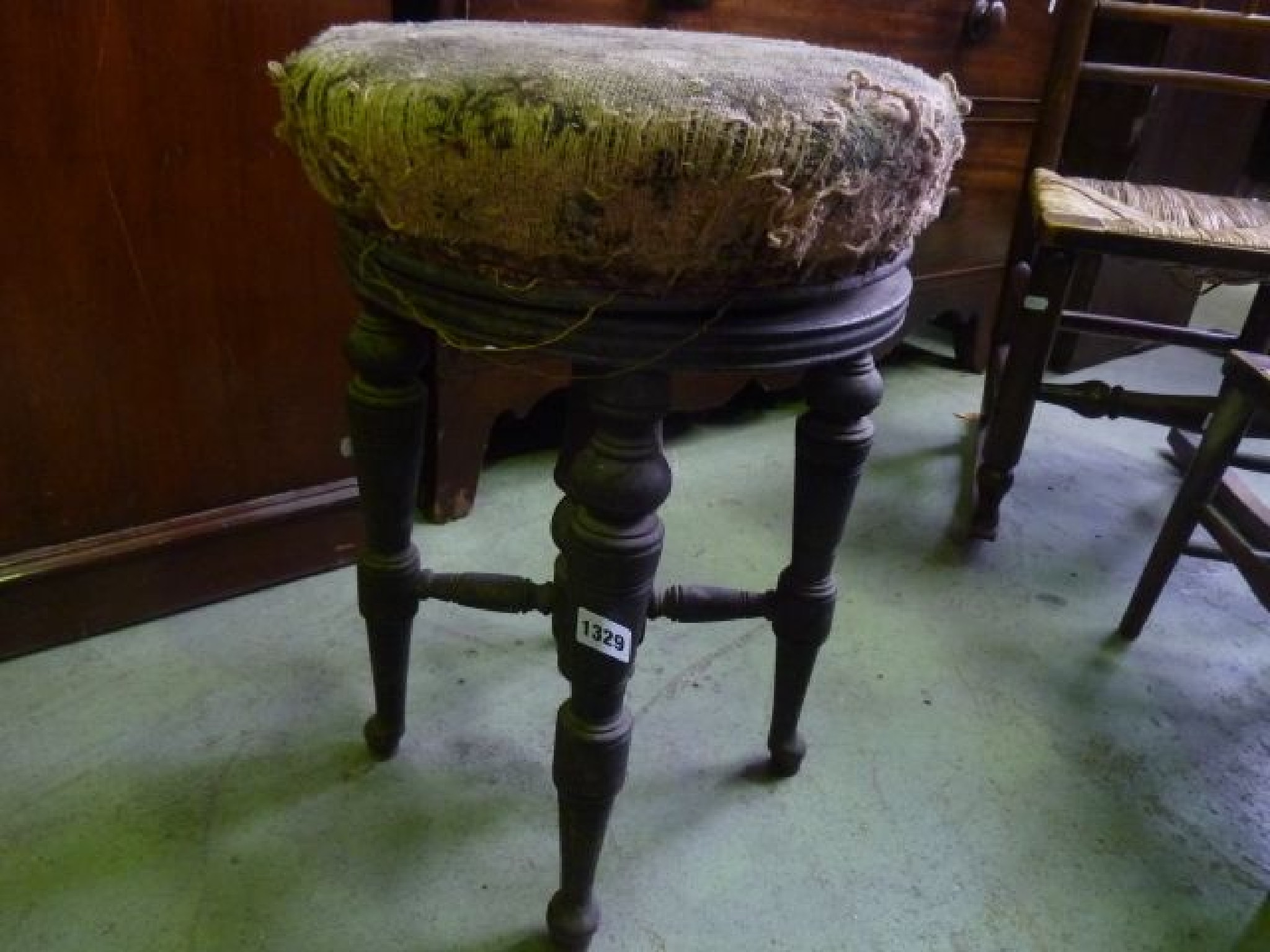 Appraisal: A Victorian piano stool with revolving seat raised on four