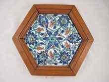 Appraisal: A hexagonal Iznik tile with traditional wild tulip decoration