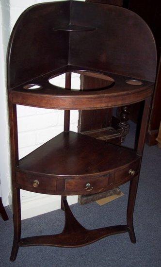 Appraisal: A George IV mahogany corner washstand with splash back and